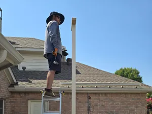 Contractor checking level on a patio cover post