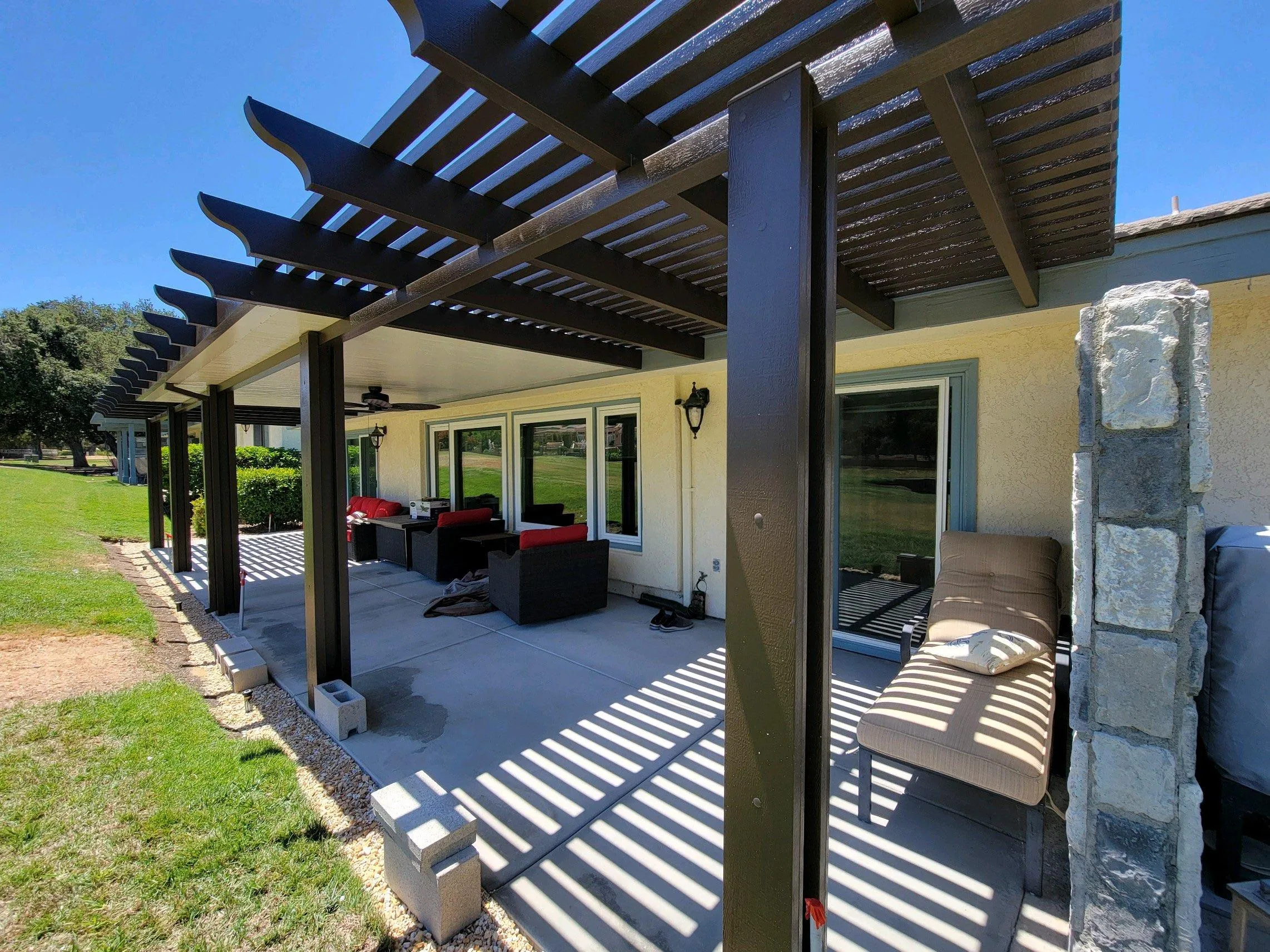 Aluminum pergola and insulated roof combination attached to home